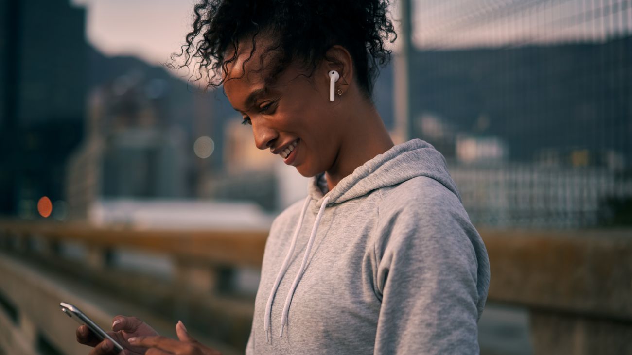 Vrouw draagt draadloze bluetooth-oortjes