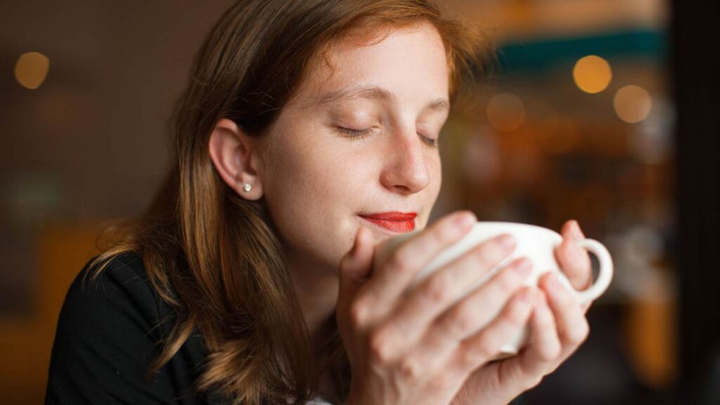 vrouw ruikt aan koffie